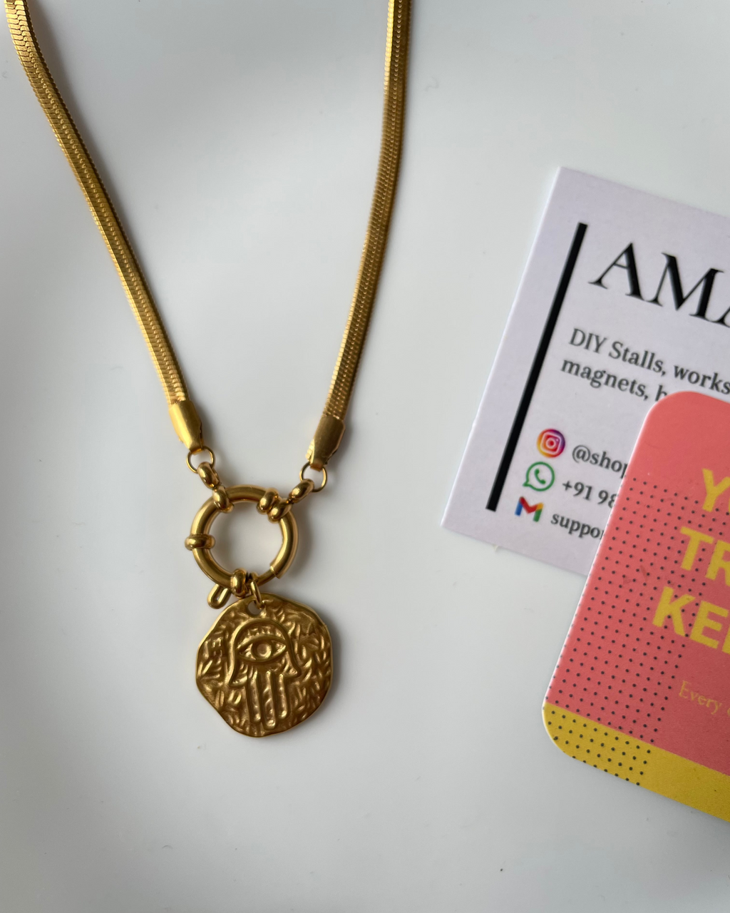 Gold necklace with a pendant on a white background