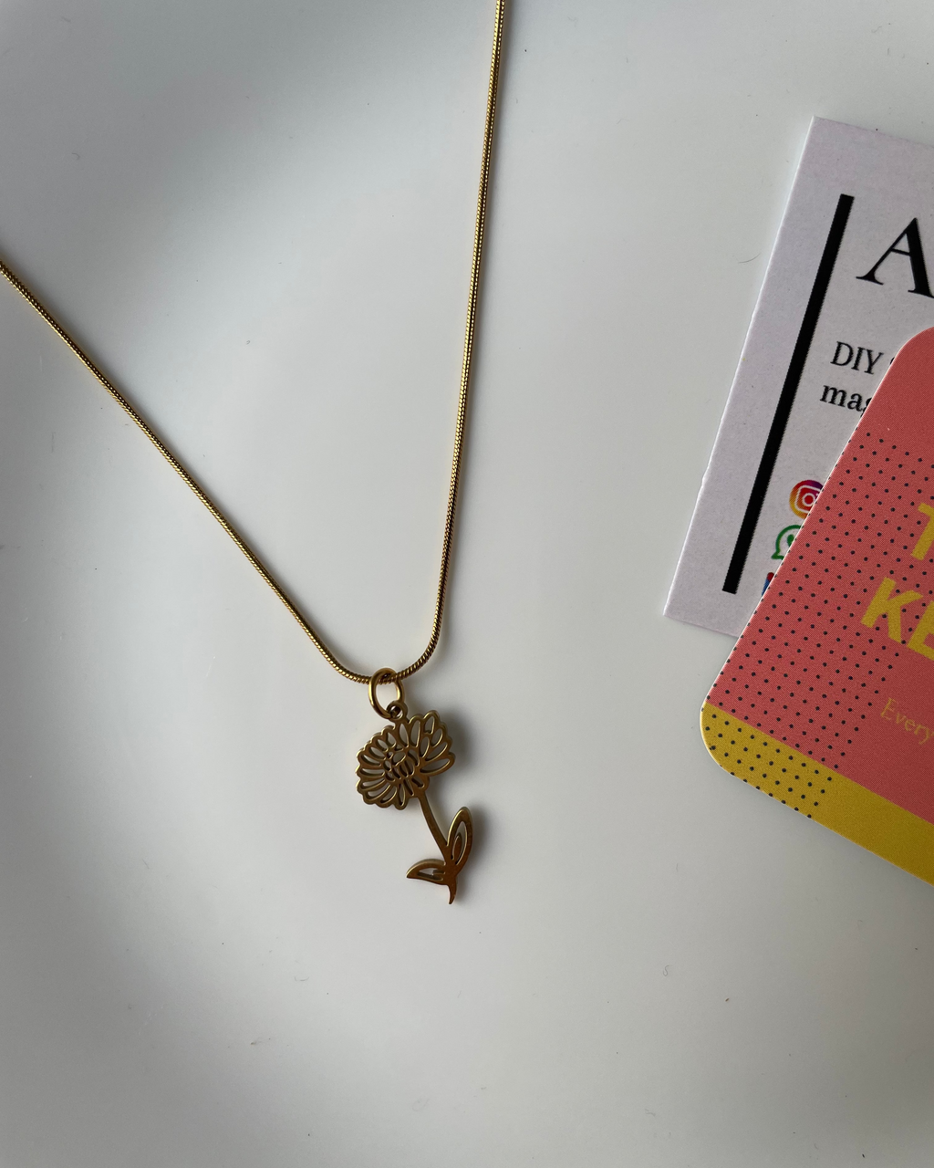 Gold hairpin with decorative element on a white surface
