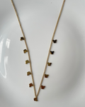 A delicate gold chain necklace featuring a series of small butterfly-shaped charms in varying shades of brown, displayed on a white surface.